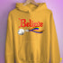 Believe Progress Pride LGBTQ Jingle Bell Hoodie - Mustard
